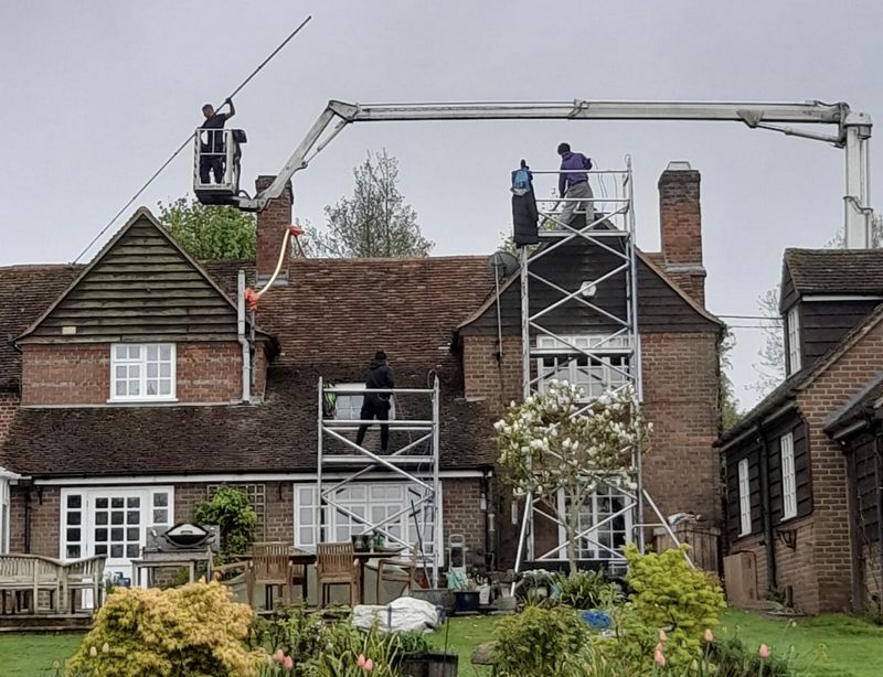 The Roof Moss Cleaners using cherry picker and scaffolding to clean roof safely and professionally in South Oxhey, Hertfordshire