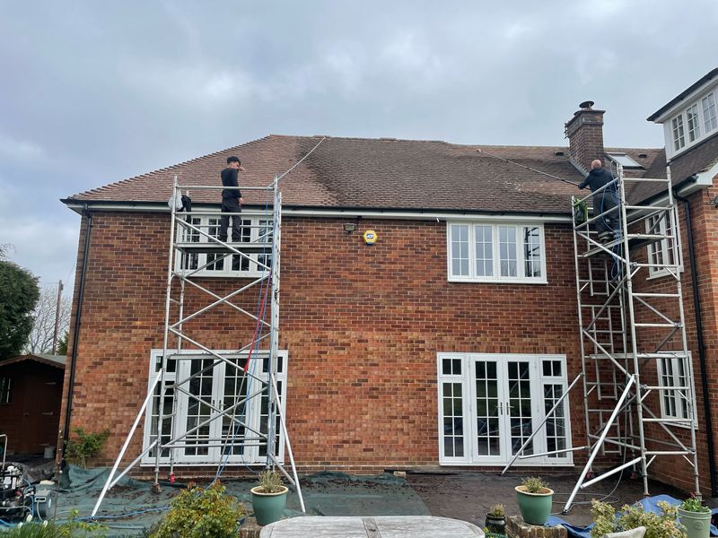 Roof cleaning carried out safely from scaffold towers by The Roof Moss Cleaners in South Oxhey